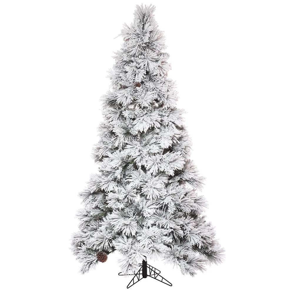A heavily flocked white Christmas tree decorated with mixed metallic ornaments for a glam look